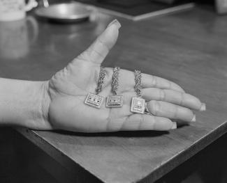 LATOYA RUBY FRAZIER, FRANCES TURNAGE, UAW LOCAL 1112, WOMEN’S COMMITTEE, HOLDING HER 10, 15, AND 20 YEARS OF SERVICE GENERAL MOTORS COMPANY ANNIVERSARY GOLD BRACELETS IN HER DINING ROOM, (34 YEARS IN AT GM LORDSTOWN COMPLEX, PAINT SHOP), YOUNGSTOWN, OH, FROM THE LAST CRUZE, 2019.